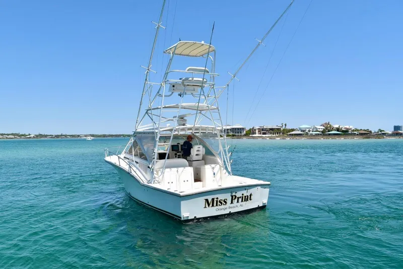 Slide: The Image of 2006 Carolina Classic 32 boat named "Miss Print" on clear blue water near Orange Beach, AL. - 6