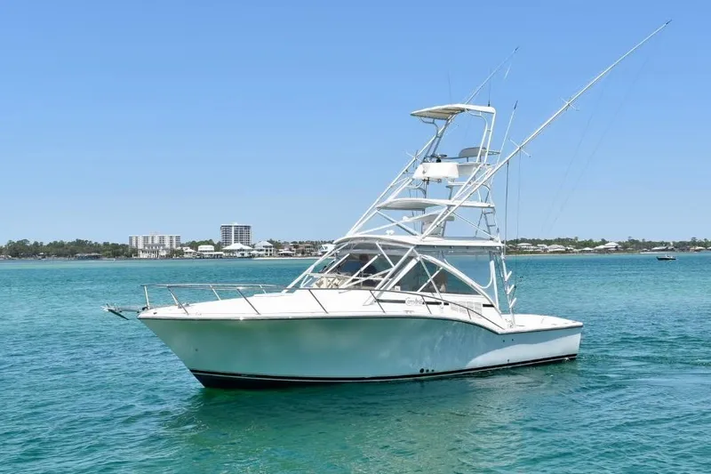 Slide: The Image of 2006 Carolina Classic 32 boat on clear blue water with distant shoreline. - 7