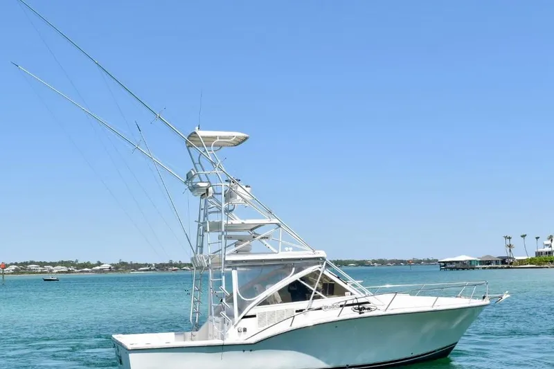 Slide: The Image of 2006 Carolina Classic 32 boat on clear blue water with distant shoreline. - 8