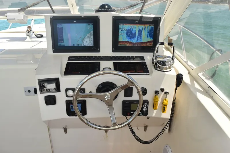 Slide: The Image of Helm of 2006 Carolina Classic 32 boat with navigation screens and controls. - 9