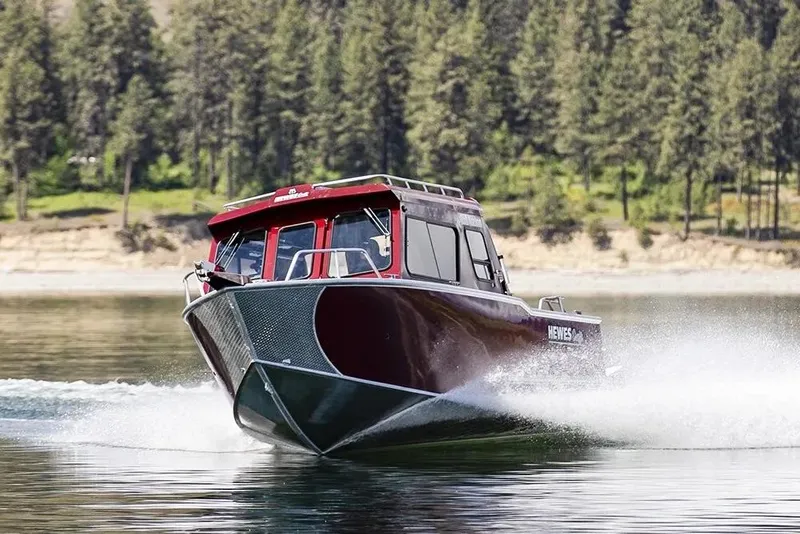 Slide: The Image of 2026 Hewescraft 270 Alaskan ET Hardtop cruising on a serene lake. - 46