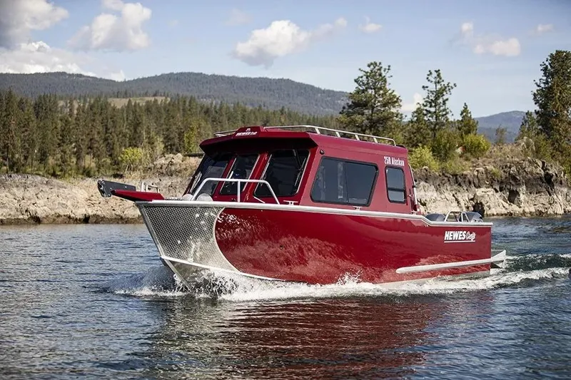 Slide: The Image of 2026 Hewescraft 270 Alaskan ET Hardtop boat cruising on a scenic lake. - 47