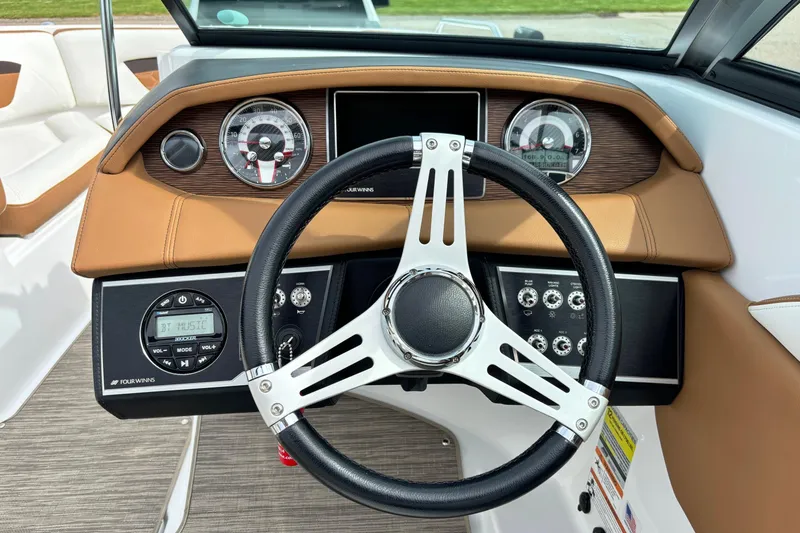 Slide: The Image of 2020 Four Winns HD220 boat dashboard with steering wheel and control panel. - 12
