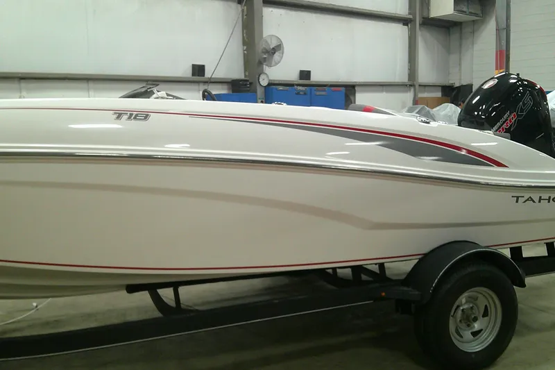 The Image of 2024 Tahoe T18 boat in a showroom, featuring sleek white design and modern detailing. - 0