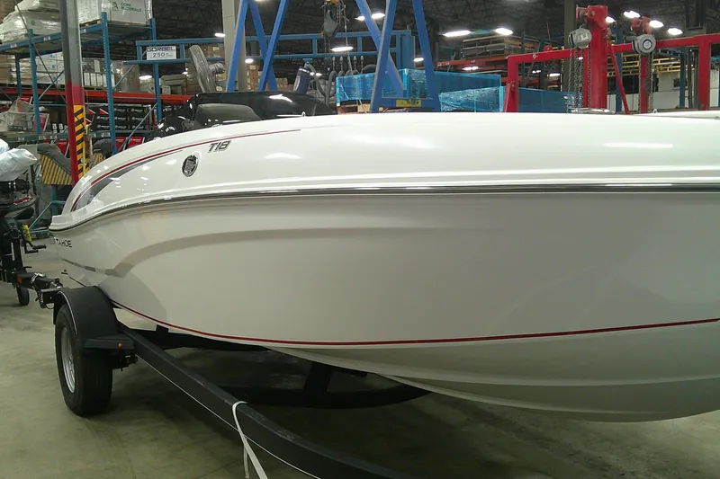 Slide: The Image of 2024 Tahoe T18 boat in a showroom, showcasing sleek white design and modern features. - 1