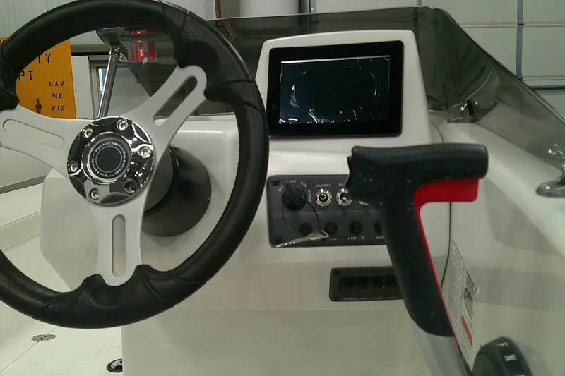 Slide: The Image of 2024 Tahoe T18 boat dashboard with steering wheel and control panel. - 4