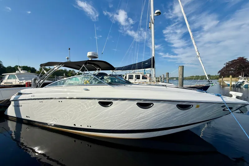 The Image of 2007 Cobalt 323 boat docked at marina under clear blue sky. - 0