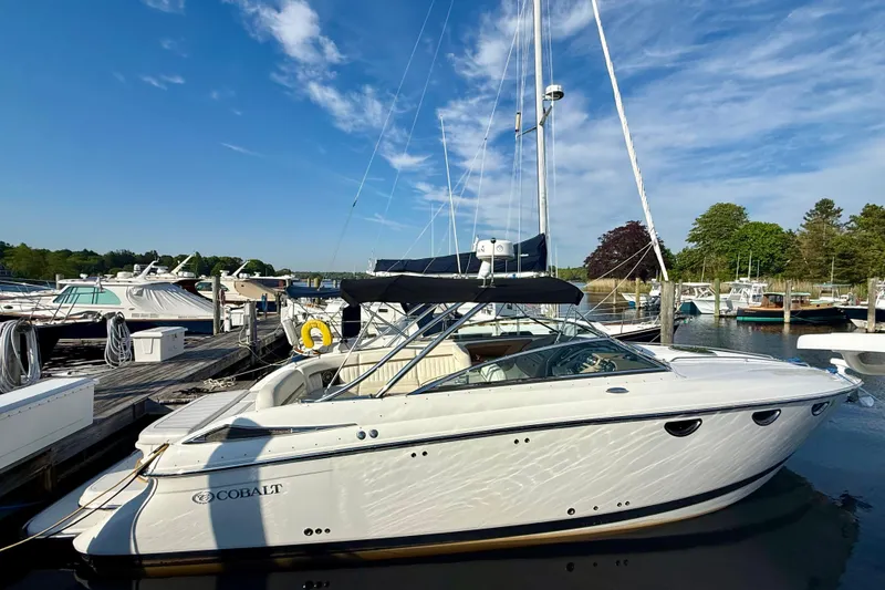 Slide: The Image of 2007 Cobalt 323 boat docked at marina under clear blue sky. - 1