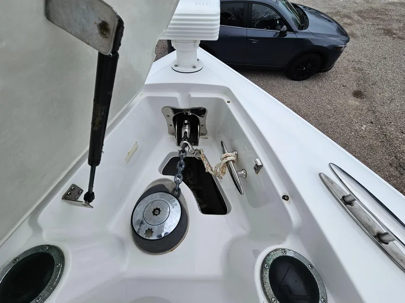 Slide: The Image of Anchor compartment of a 2007 Cobalt 323 boat with a car in the background. - 19