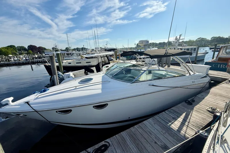 Slide: The Image of 2007 Cobalt 323 boat docked at marina under clear blue sky. - 2