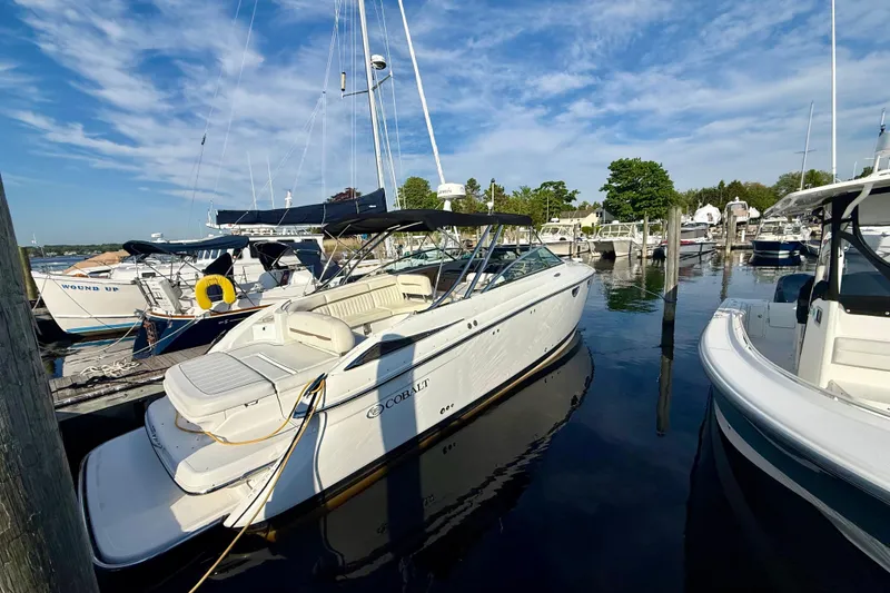 Slide: The Image of 2007 Cobalt 323 boat docked at marina under clear blue sky. - 3