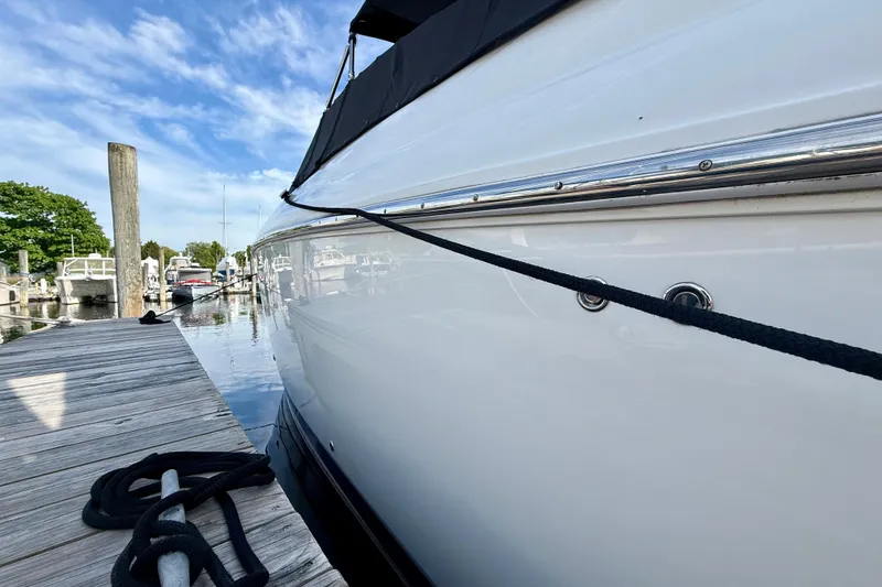 Slide: The Image of 2007 Cobalt 323 boat docked at marina with clear blue sky. - 5