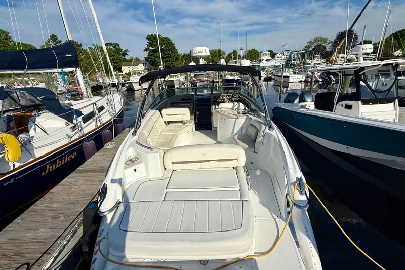 Slide: The Image of 2007 Cobalt 323 boat docked at marina, surrounded by other boats under a clear sky. - 7