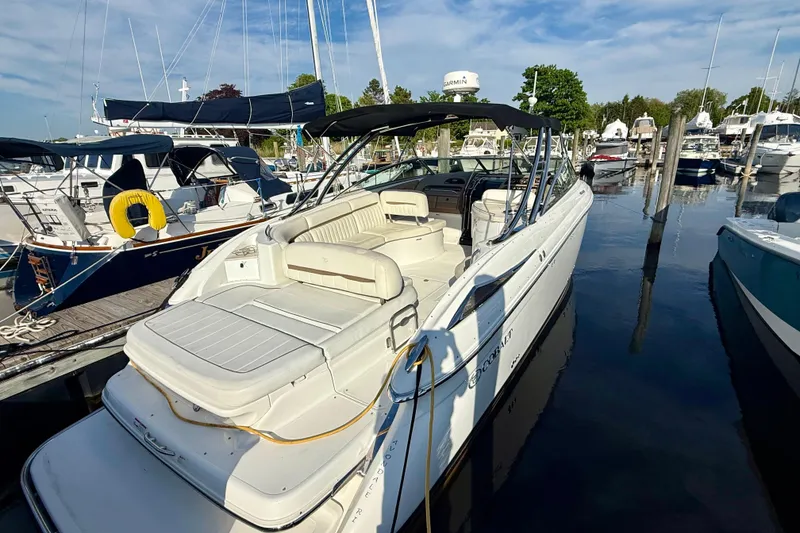 Slide: The Image of 2007 Cobalt 323 boat docked at marina, featuring spacious seating and sleek design. - 8