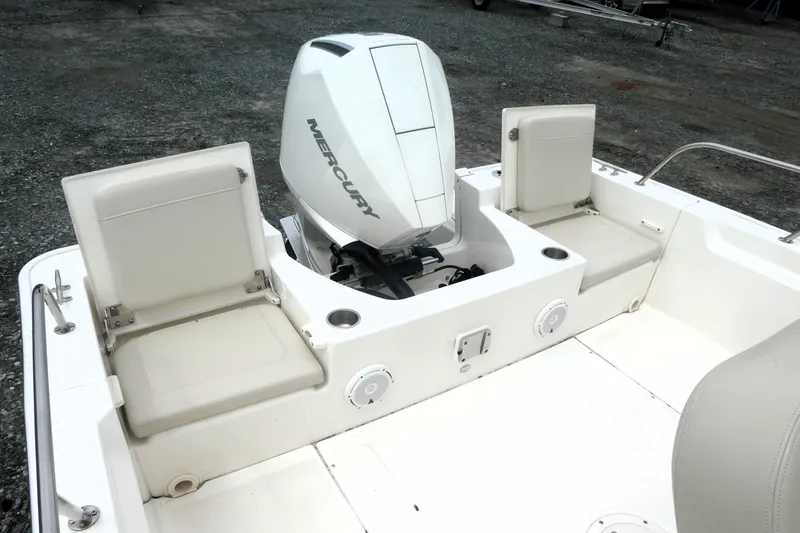 Slide: The Image of 2023 Boston Whaler 210 Montauk boat with Mercury engine and seating area. - 4