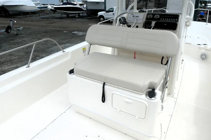 Slide: The Image of 2023 Boston Whaler 210 Montauk boat interior with beige seating and control panel. - 5