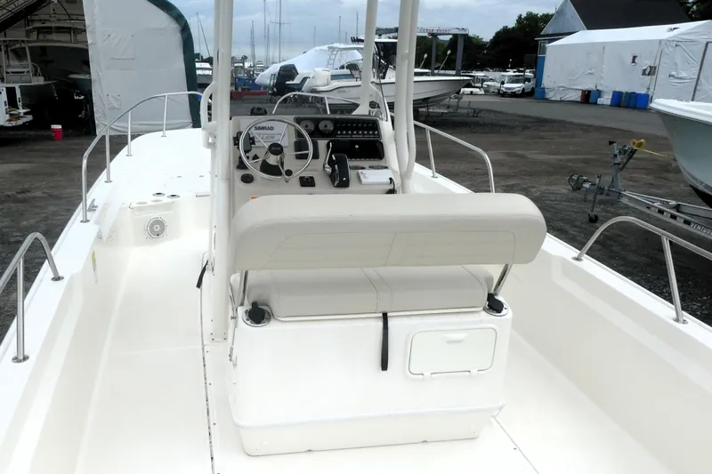 Slide: The Image of 2023 Boston Whaler 210 Montauk boat interior with steering console and seating. - 6