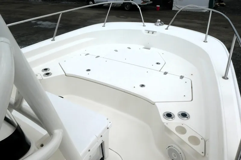 Slide: The Image of 2023 Boston Whaler 210 Montauk boat deck with storage compartments and cup holders. - 8