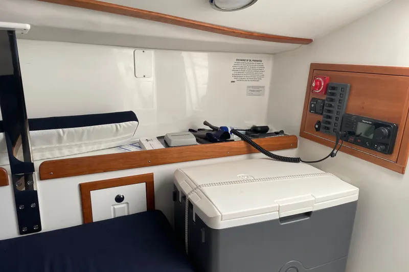 Slide: The Image of Interior of 2025 Tartan Fantail boat with control panel and storage area. - 14