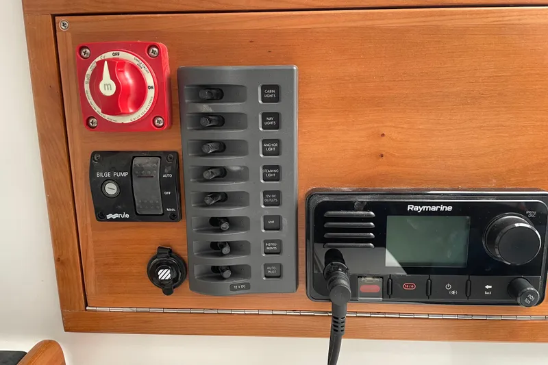 Slide: The Image of Control panel of 2025 Tartan Fantail boat with switches and Raymarine device. - 15