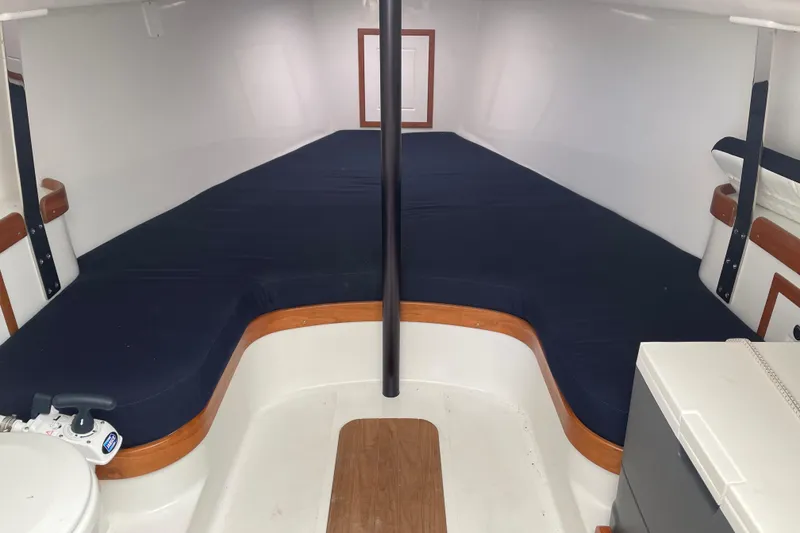 Slide: The Image of Interior of 2025 Tartan Fantail sailboat with blue cushions and wooden accents. - 16