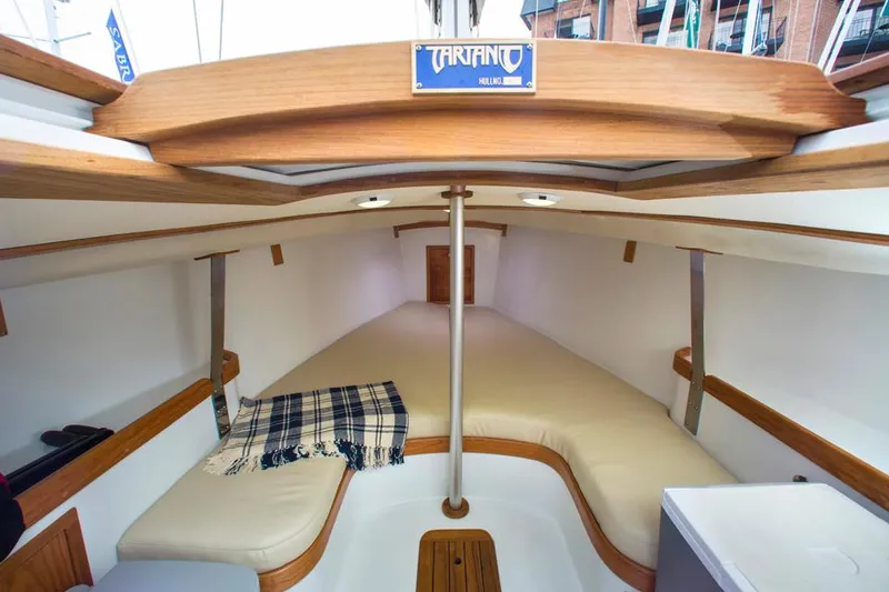 Slide: The Image of Manufacturer Provided Image: Interior of 2025 Tartan Fantail sailboat with cozy seating and plaid blanket. - 4