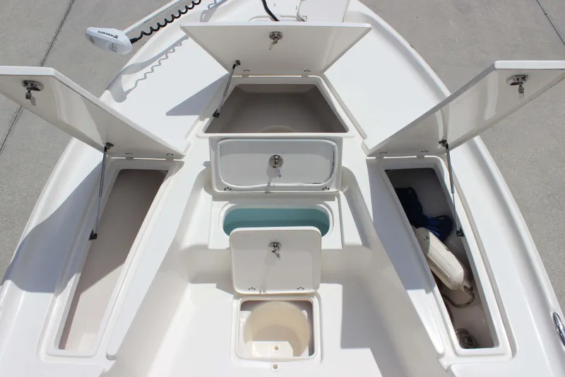 Slide: The Image of 2026 Key West 230 Bay Reef boat storage compartments open on deck. - 15