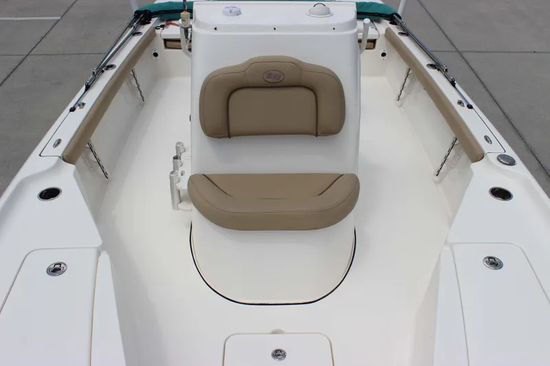 Slide: The Image of 2026 Key West 230 Bay Reef boat interior with tan seating and white deck. - 16