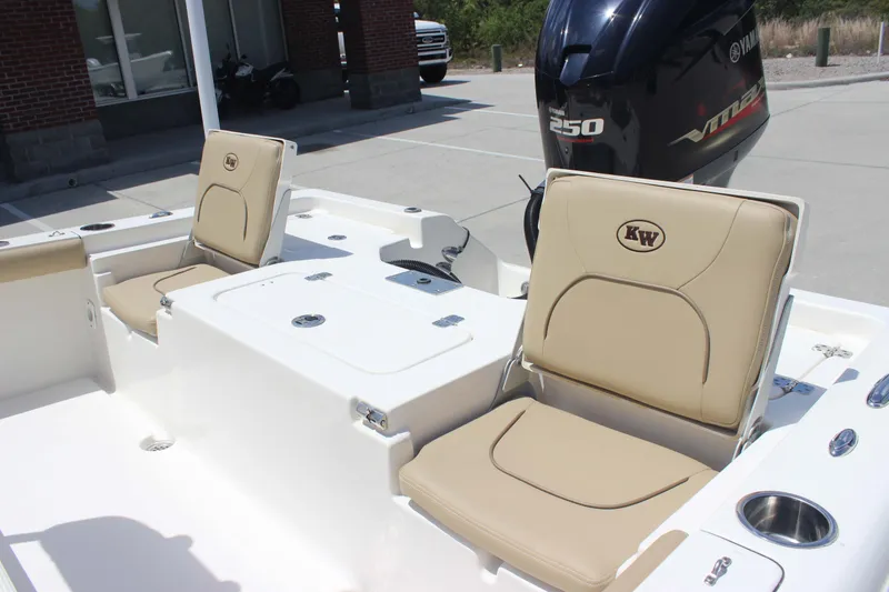 Slide: The Image of 2026 Key West 230 Bay Reef boat interior with beige seating and Yamaha engine. - 20
