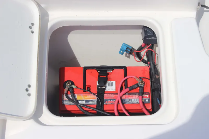Slide: The Image of Battery compartment of 2026 Key West 230 Bay Reef boat with red battery and wiring. - 23