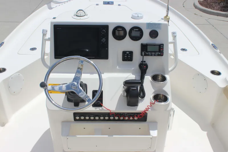 Slide: The Image of 2026 Key West 230 Bay Reef boat console with steering wheel and navigation controls. - 4