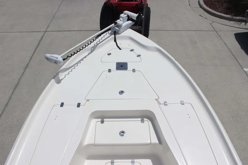 Slide: The Image of 2026 Key West 230 Bay Reef boat deck with storage compartments and trolling motor. - 7