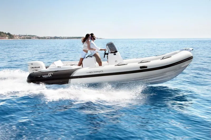 Slide: The Image of 2023 Ranieri CAYMAN 21 SPORT inflatable boat cruising on open water. - 1