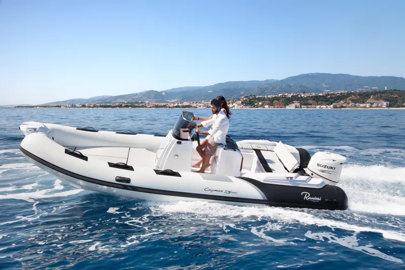 Slide: The Image of 2023 Ranieri CAYMAN 21 SPORT boat cruising on open water. - 6
