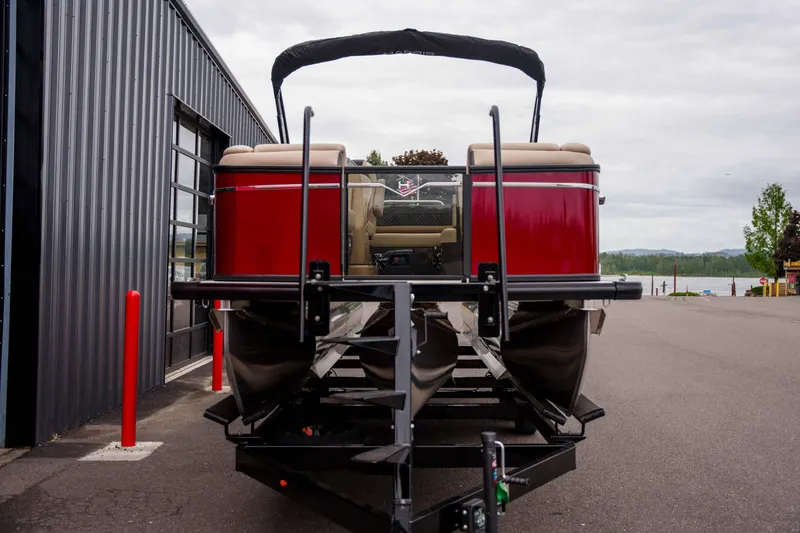 Slide: The Image of 2026 Harris Sunliner 230 pontoon boat on trailer near waterfront. - 16