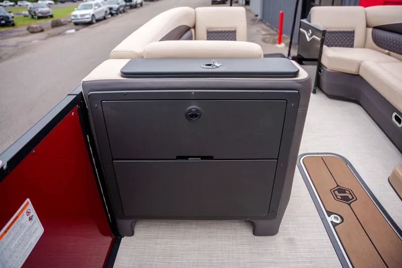 Slide: The Image of 2026 Harris Sunliner 230 interior with seating and storage compartment. - 28