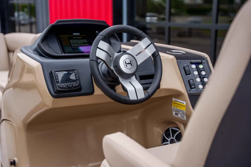 Slide: The Image of 2026 Harris Sunliner 230 boat dashboard with modern steering wheel and control panel. - 30