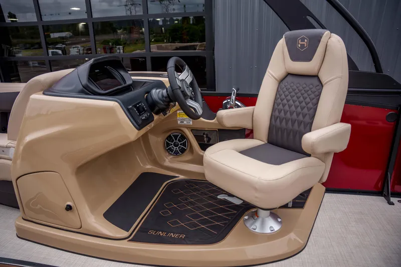 Slide: The Image of Captain's chair and helm of 2026 Harris Sunliner 230 boat, featuring modern design and controls. - 31