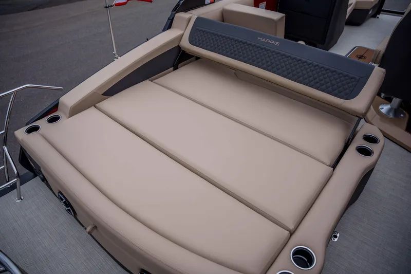 Slide: The Image of 2026 Harris Sunliner 230 boat with luxurious beige seating and integrated cup holders. - 33