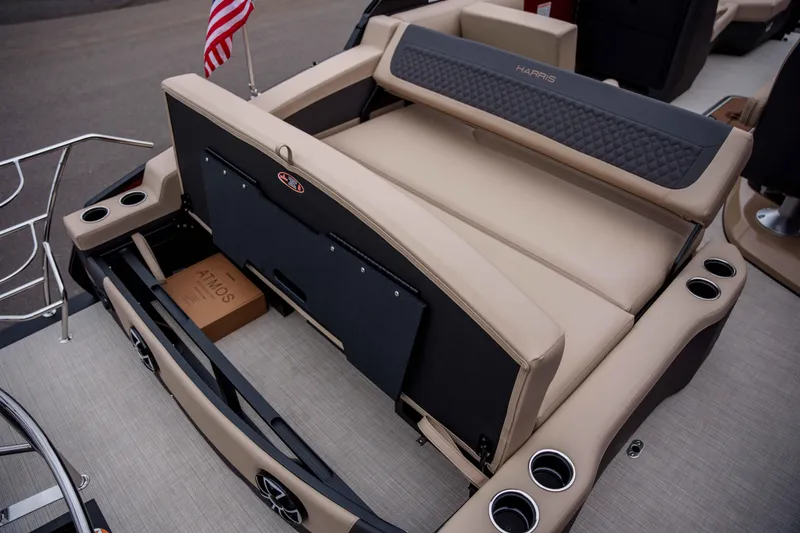 Slide: The Image of 2026 Harris Sunliner 230 boat interior with beige seating and cup holders. - 34