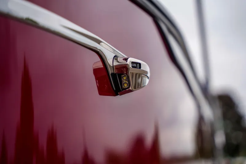 Slide: The Image of Close-up of 2026 Harris Sunliner 230 side mirror on a glossy red surface. - 40