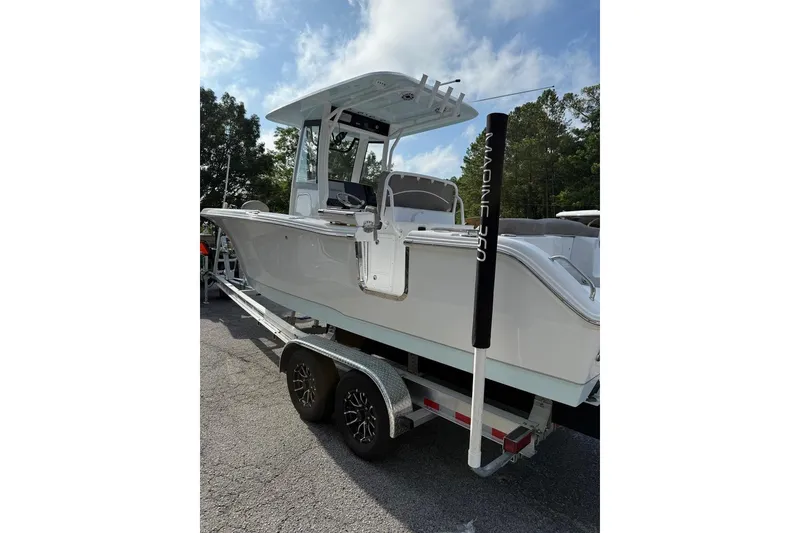 Slide: The Image of 2026 Sea Hunt Ultra 255 SE boat on trailer, parked outdoors. - 12