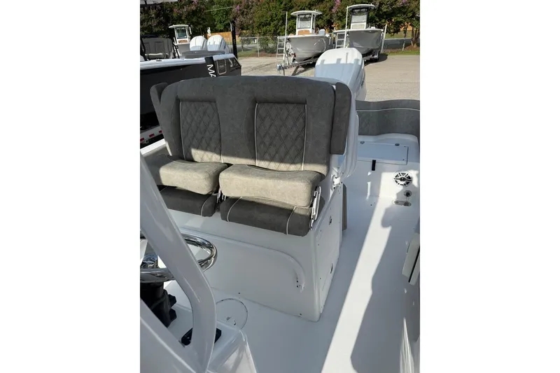 Slide: The Image of 2026 Sea Hunt Ultra 255 SE boat interior with cushioned seating and steering wheel. - 17