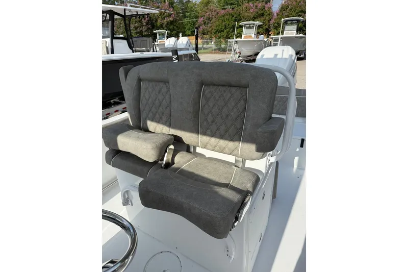 Slide: The Image of Gray cushioned seating on 2026 Sea Hunt Ultra 255 SE boat, featuring diamond stitching. - 18