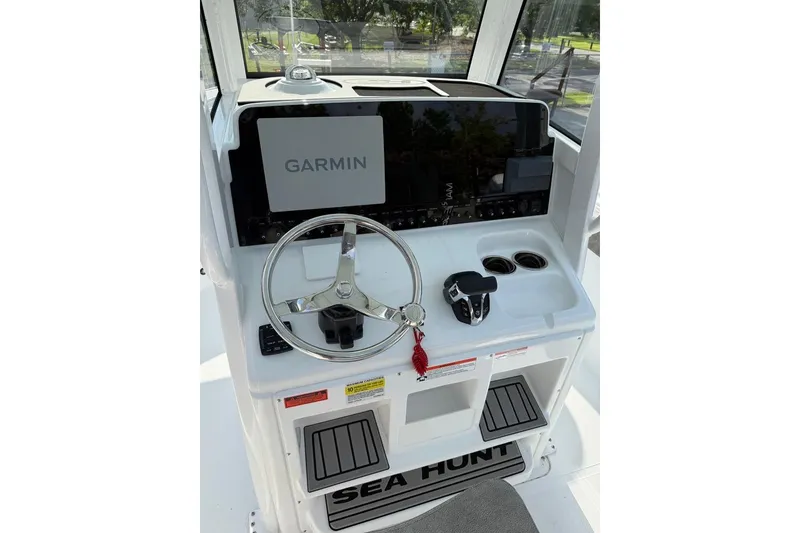 Slide: The Image of 2026 Sea Hunt Ultra 255 SE boat console with Garmin navigation system and steering wheel. - 19