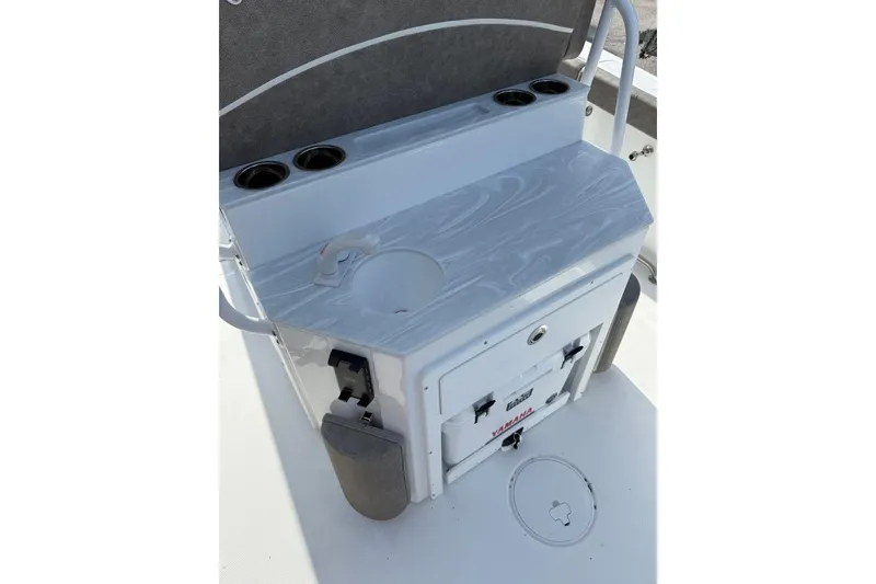 Slide: The Image of Sea Hunt Ultra 255 SE 2026 boat console with cup holders and storage compartment. - 22