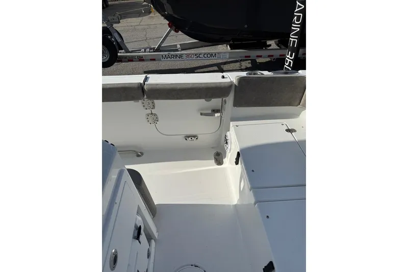 Slide: The Image of 2026 Sea Hunt Ultra 255 SE boat interior, featuring seating and storage compartments. - 25