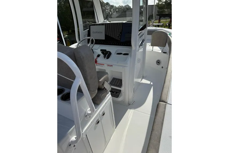 Slide: The Image of 2026 Sea Hunt Ultra 255 SE boat interior with Garmin navigation system and seating. - 26