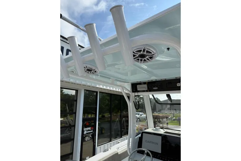 Slide: The Image of Interior view of 2026 Sea Hunt Ultra 255 SE boat with rod holders and speakers. - 27