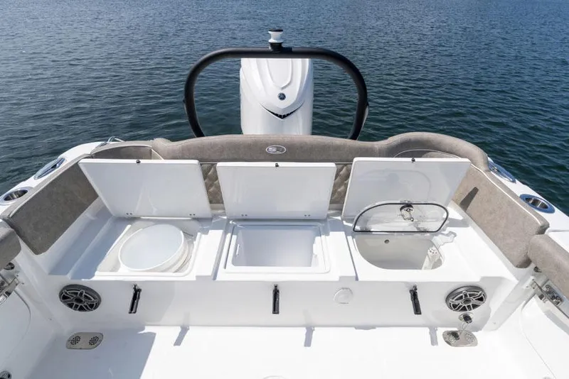 Slide: The Image of Manufacturer Provided Image: 2026 Sea Hunt Ultra 255 SE boat interior with open storage compartments on calm water. - 9